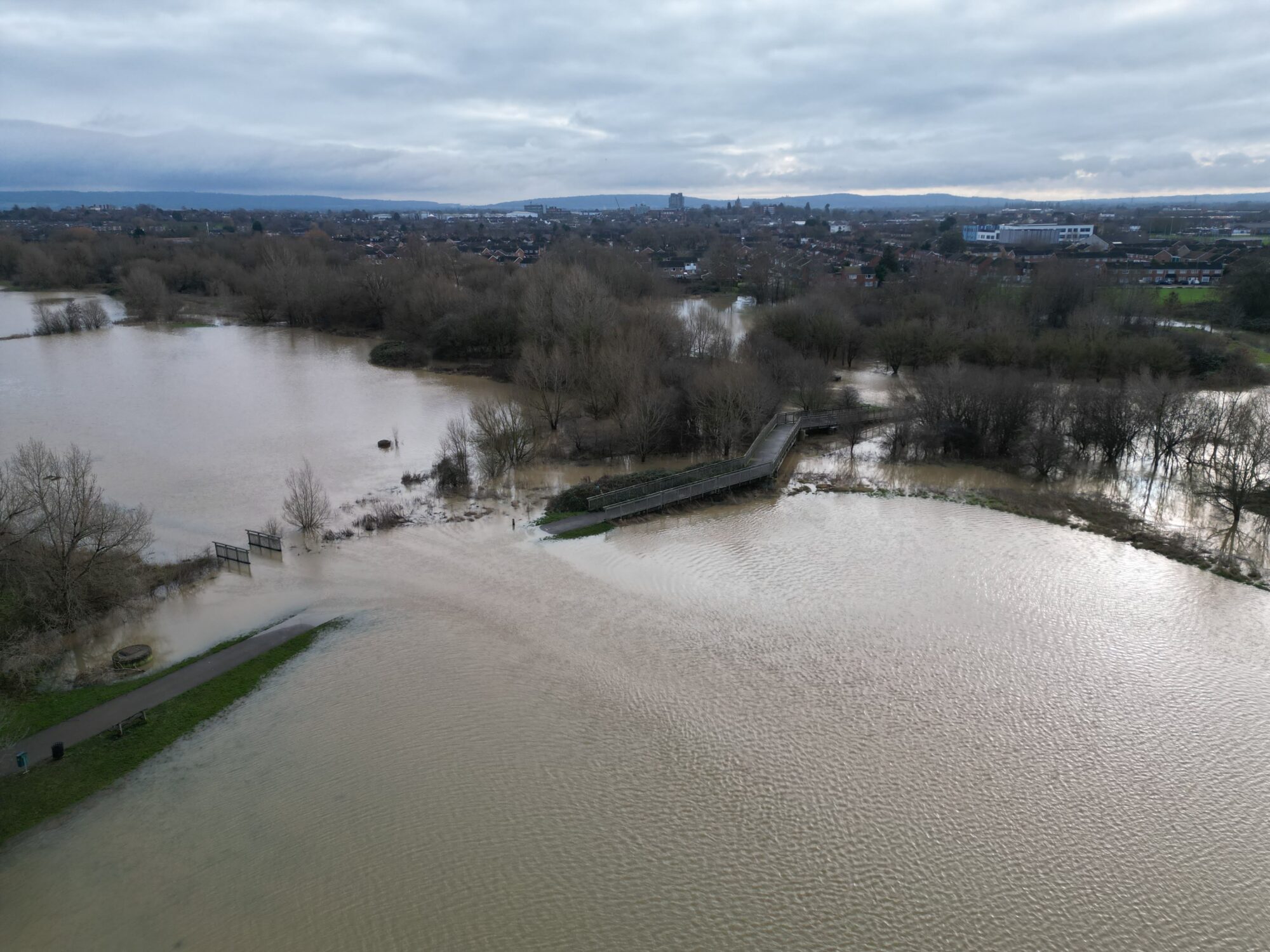 Drone imagery of flood waters. The footbridge in Buckingham Park in north Aylesbury is cut off by flood waters. By skyeyeimagery.com