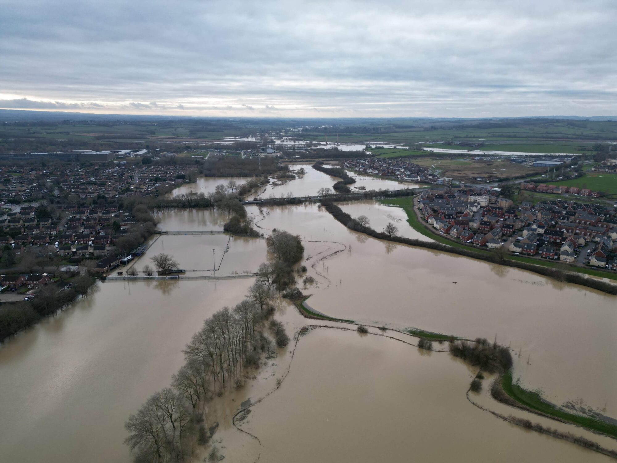 Drone imagery of flood waters. Stretch of flood water separating Haydon Hill and Berryfields in north Aylesbury. This area is usually green fields. The floodplains are working hard. By skyeyweimagery.com