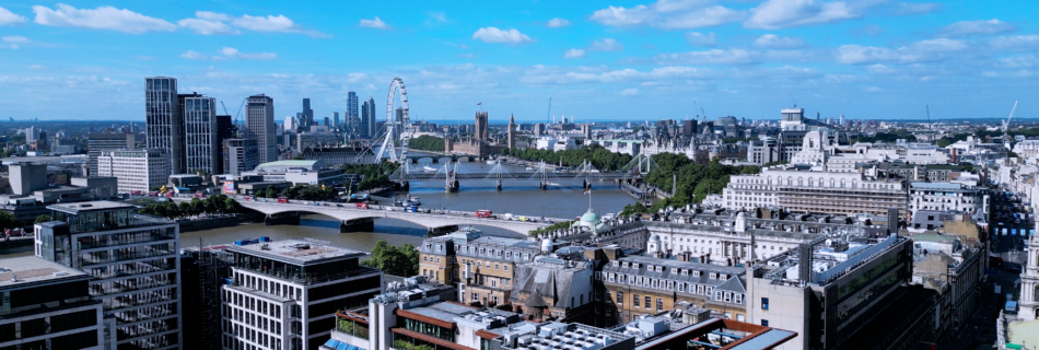 Drone image of the River Thames, facing towards the London Eye and Palace of Westminster.